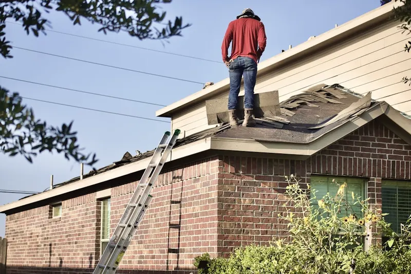 Professional roofer working on a residential roof in Gambier